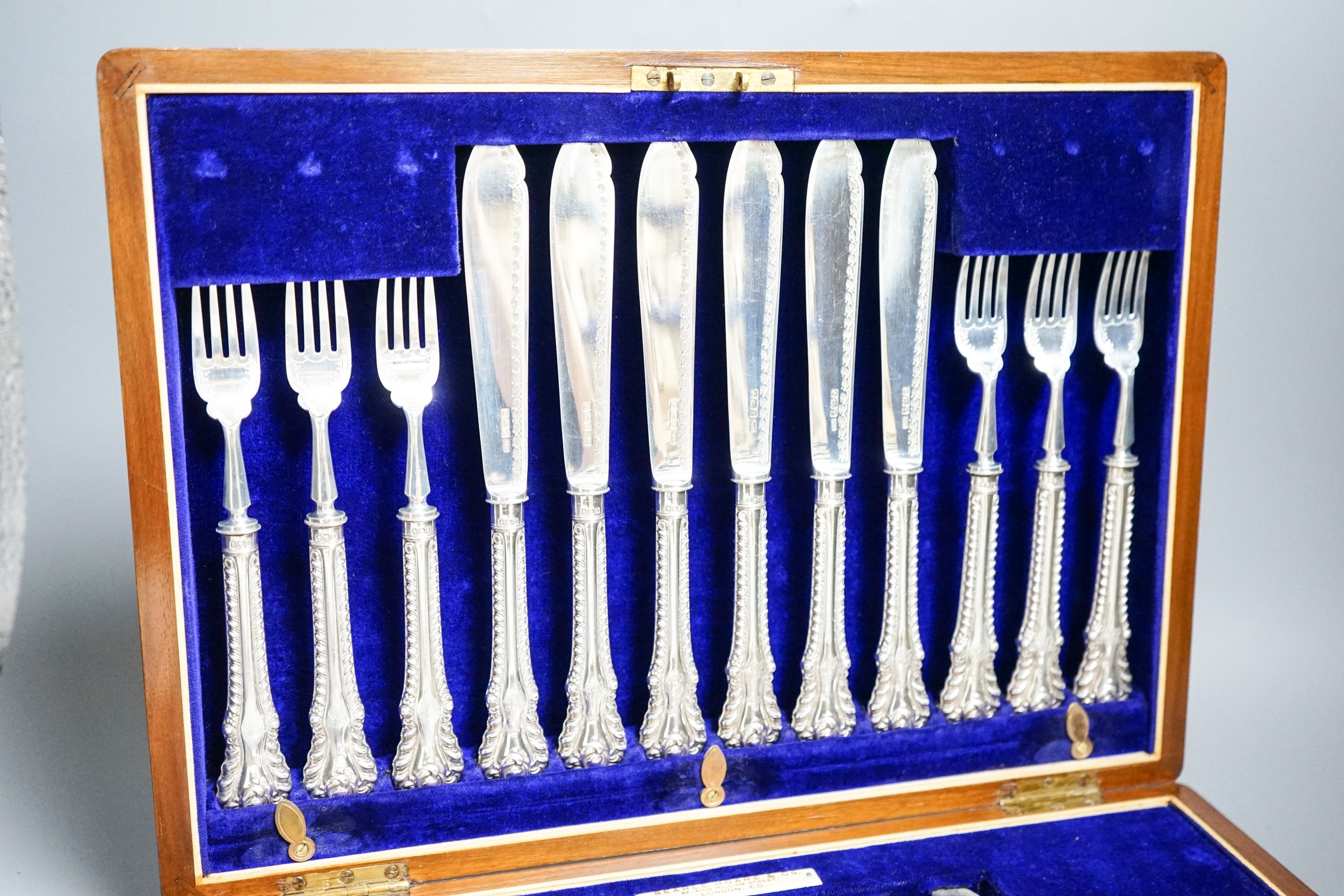 A cased set of twelve pairs of Edwardian silver fish eaters, Allen & Darwin, Sheffield, 1909 (loaded handles)